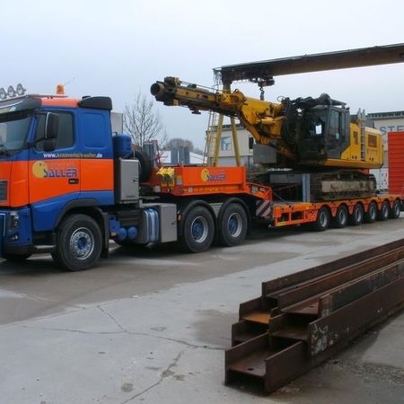 Schwerer Lastwagen transportiert große Maschine